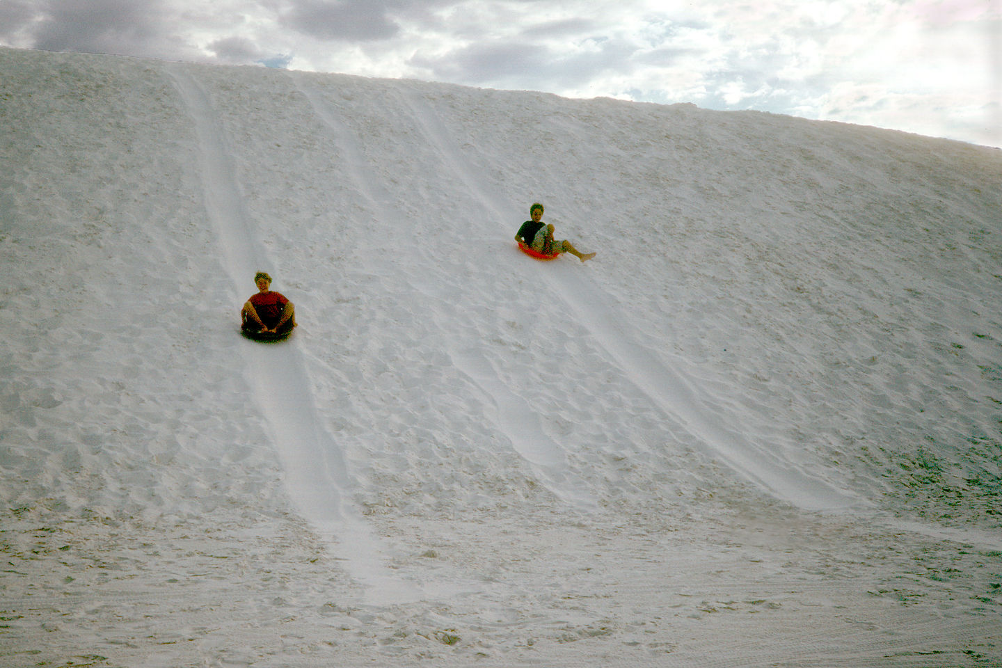 Boys saucering down dunes Boys saucering down dunes