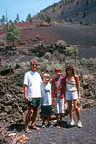 Family hiking through the lava flow