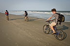 Family biking along shoreline