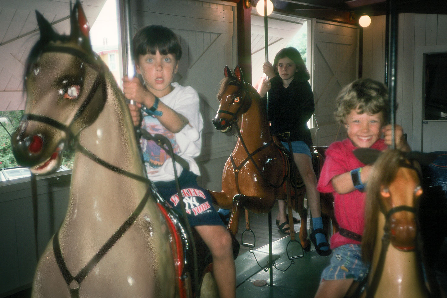 Andrew and Tommy riding Flying Horses Carousel