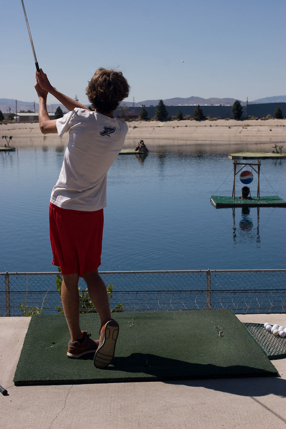 Tommy driving golf balls