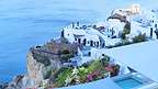 Oia's whitewashed cubiform houses carved into the cliffs