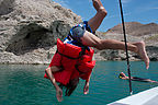 Andrew diving off boat with many preservers - TJG