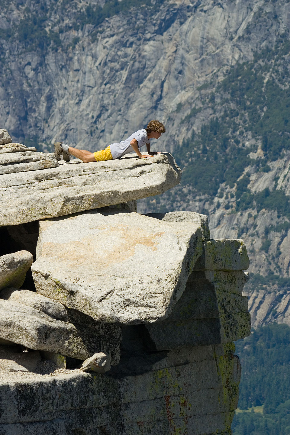 Tommy peering over Half Dome ledge - AJG