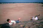 Boys rolling down the Jocky Ridge dune