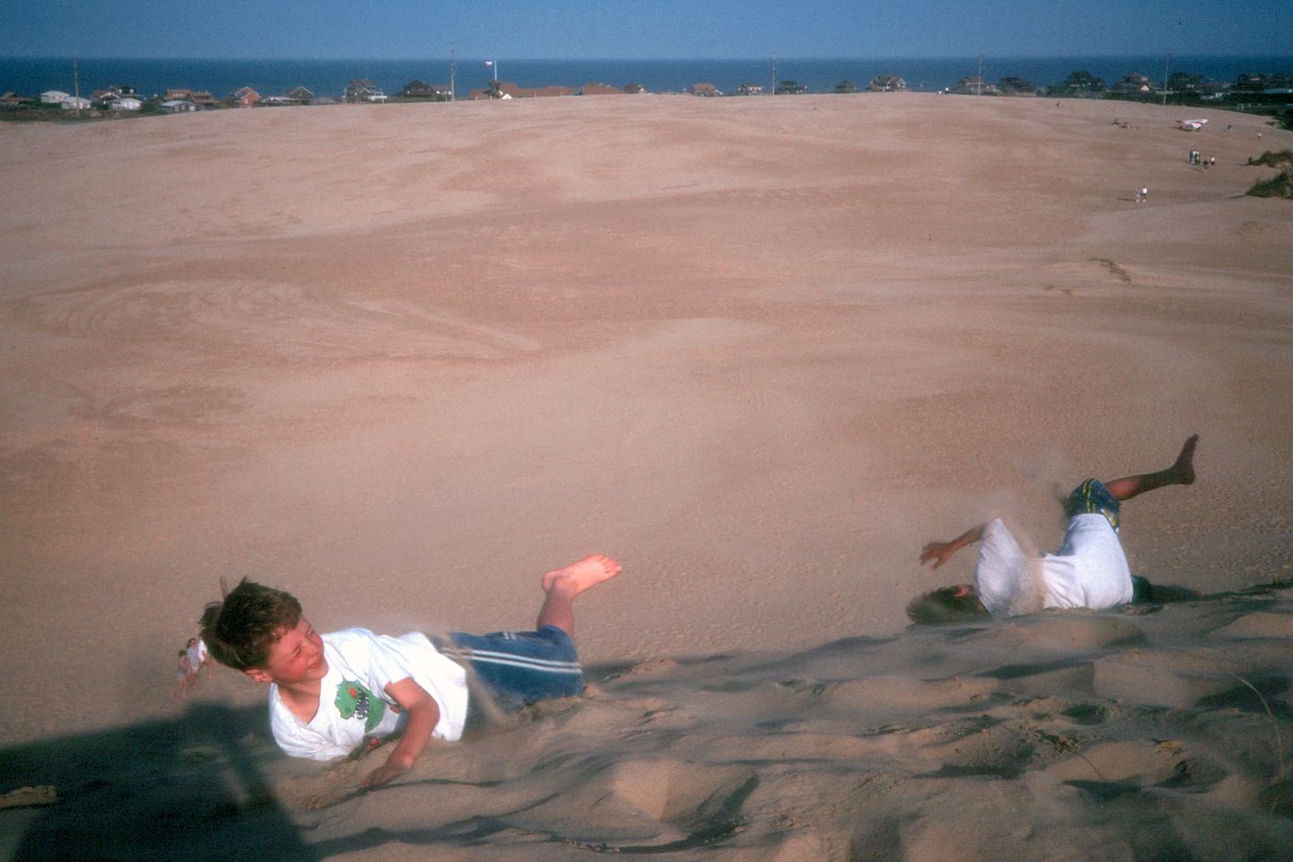 Boys rolling down the Jocky Ridge dune Boys rolling down the Jocky Ridge dune