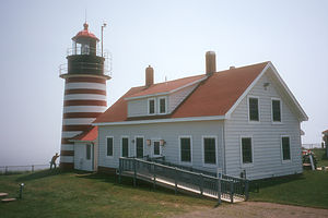 Herb holding up Quoddy Head Light