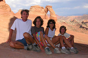 Windblown family reaches Delicate Arch