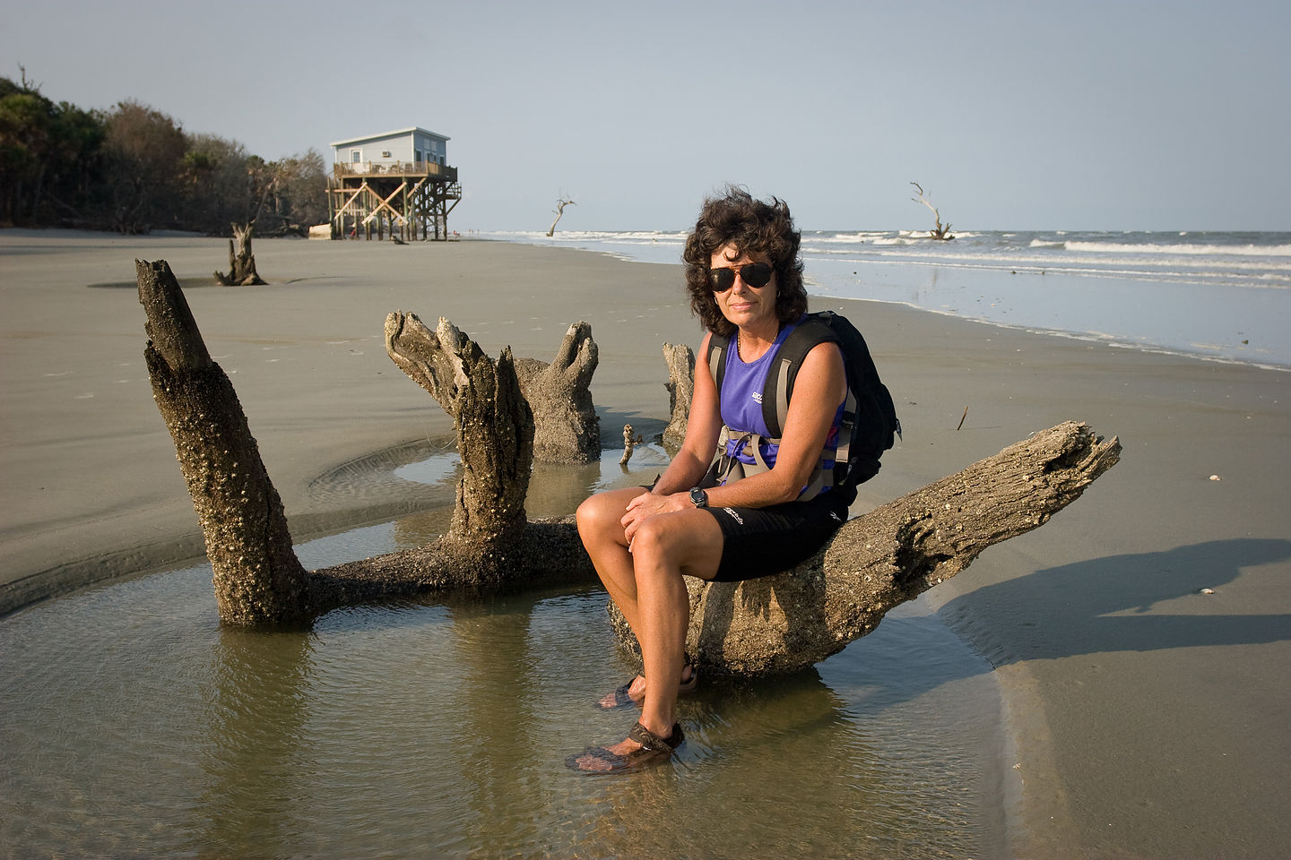 Lolo sitting on beach log