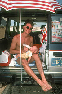 Herb and baby Andrew Tailgating in back of Isuzu Trooper