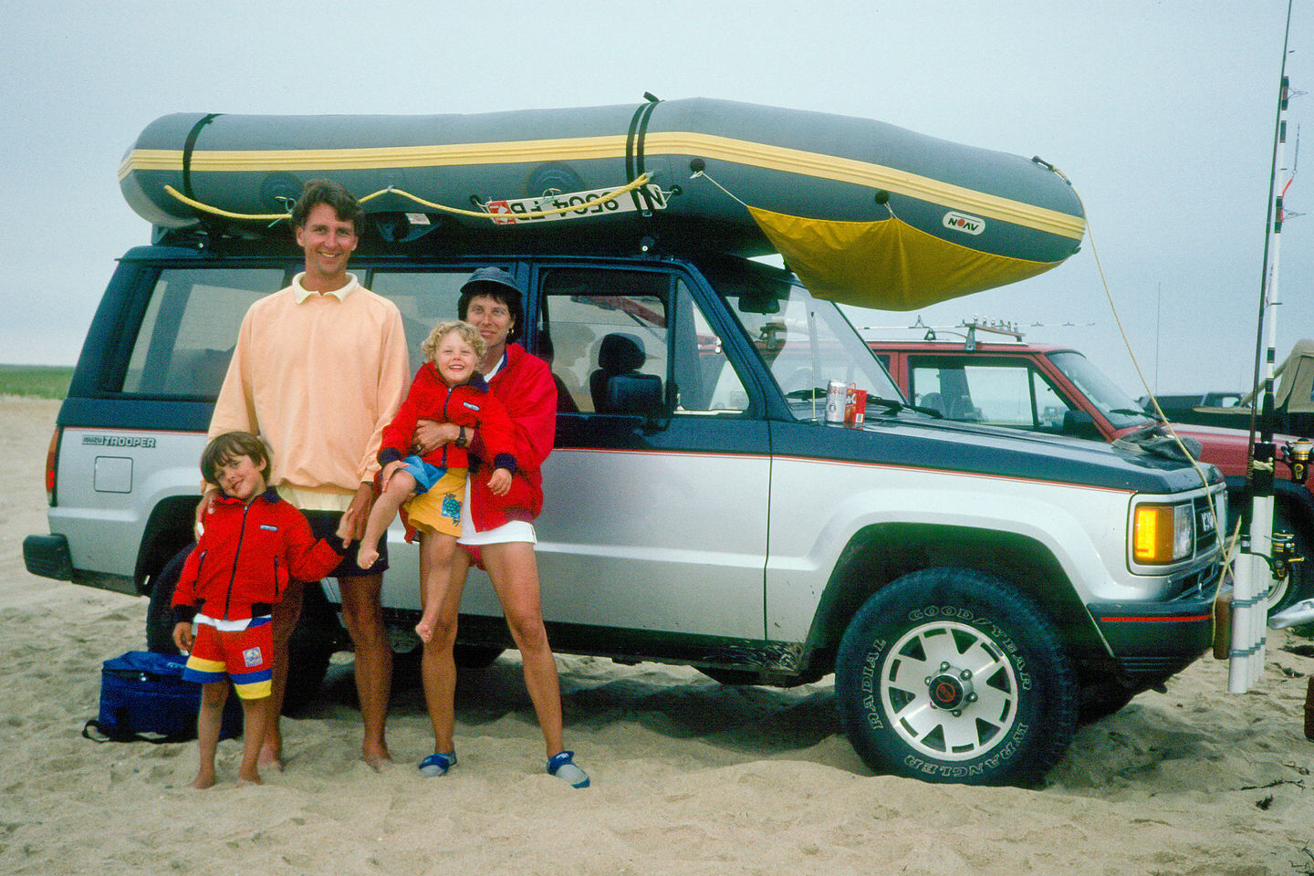 Family on beach with Isuzu Trooper and Avon Redshank