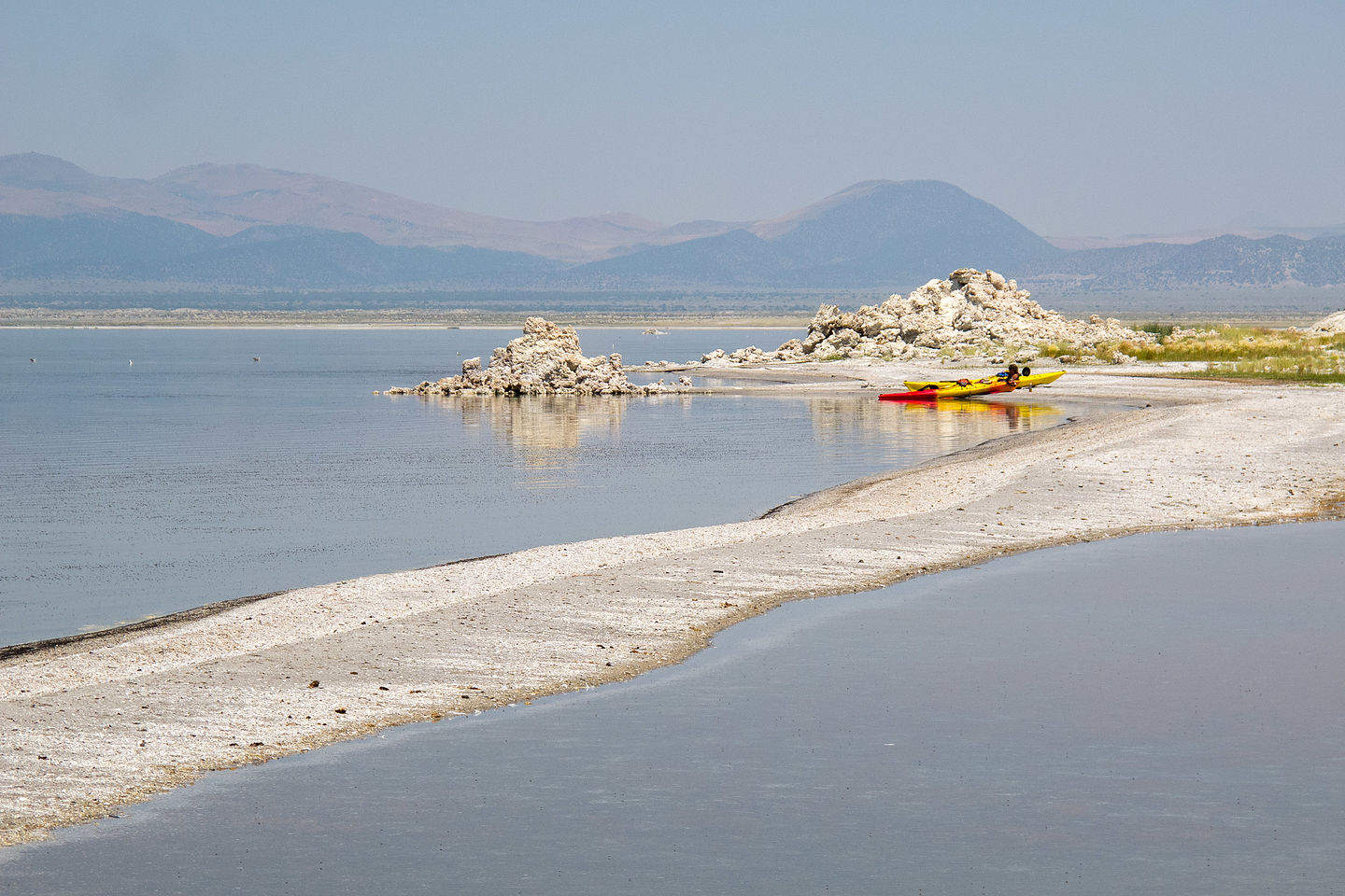 Sand spit by remote tufas