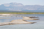 Sand spit by remote tufas