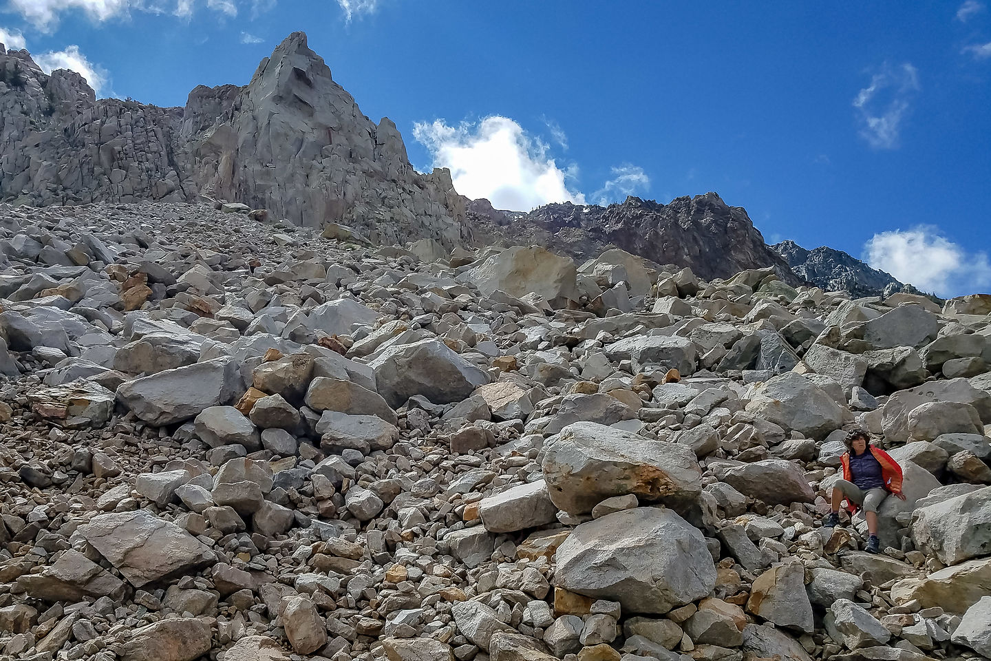 Lolo scrambling up the talus to Cardinal Pinnacle