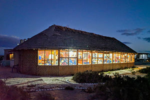 Campers gathered for dinner in cozy palapa