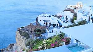 Oia's whitewashed cubiform houses carved into the cliffs