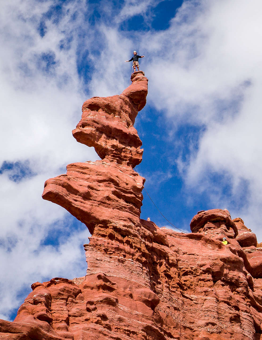 Climber atop the corkscrew summit of the Ancient Art formation