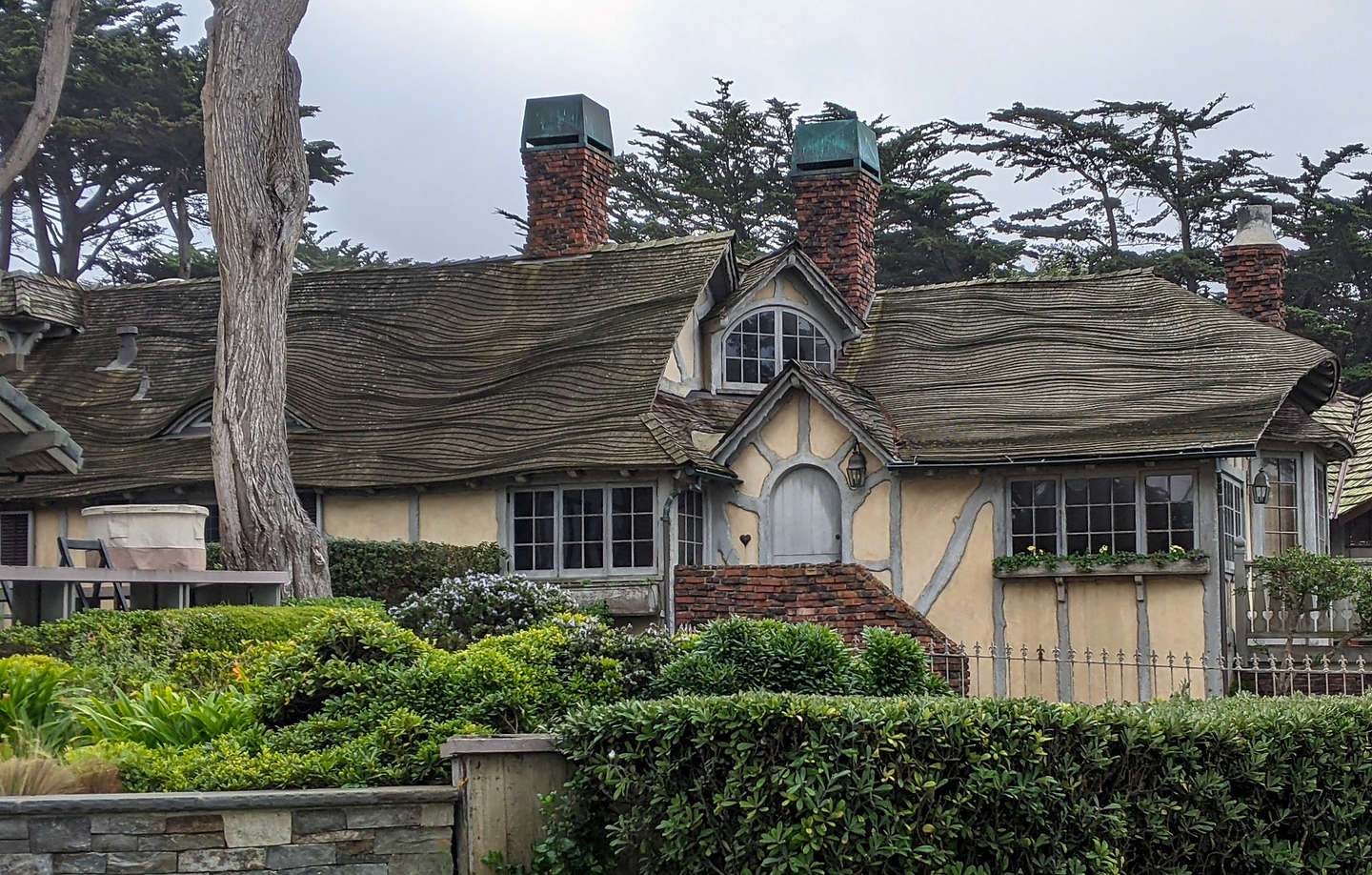 Fairy-tale gingerbread houses with stone chimneys and wavy pitched roofs. Fairy-tale gingerbread houses with stone chimneys and wavy pitched roofs.
